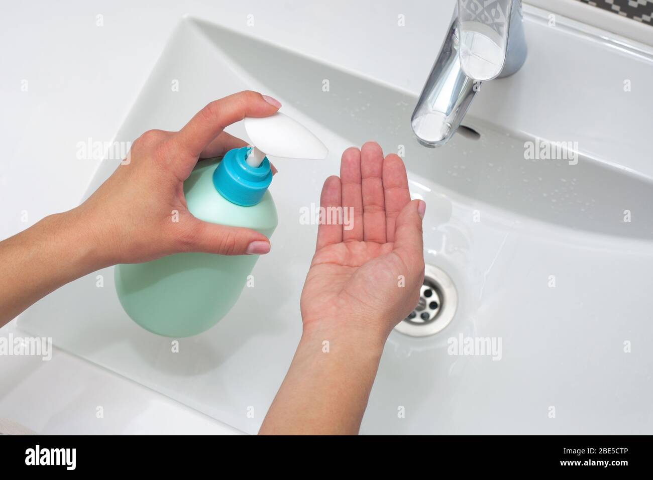 Hand washing. A woman uses soap to wash her hands. hygiene concept