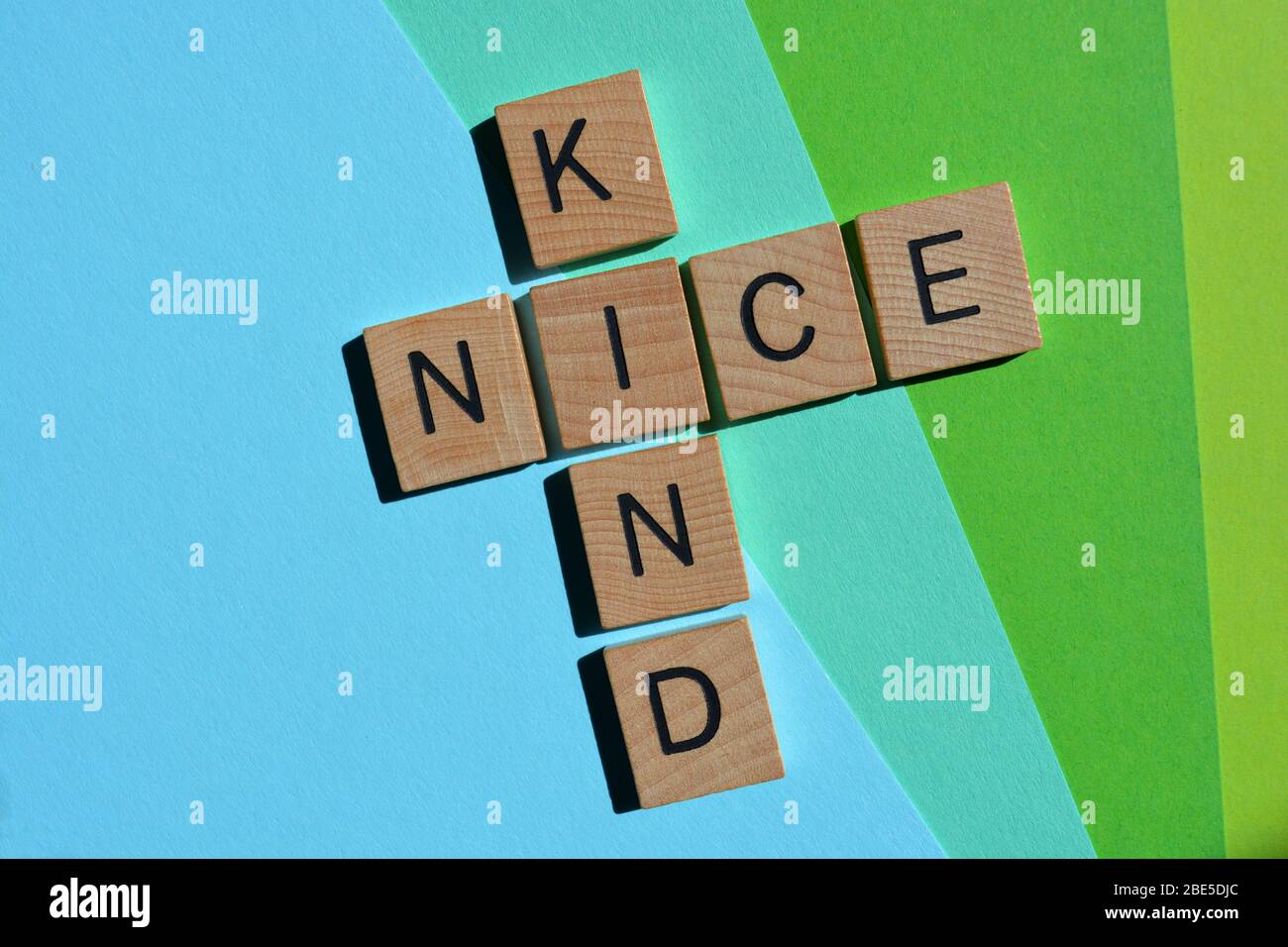 Kind, Nice,  crossword on green and blue Stock Photo