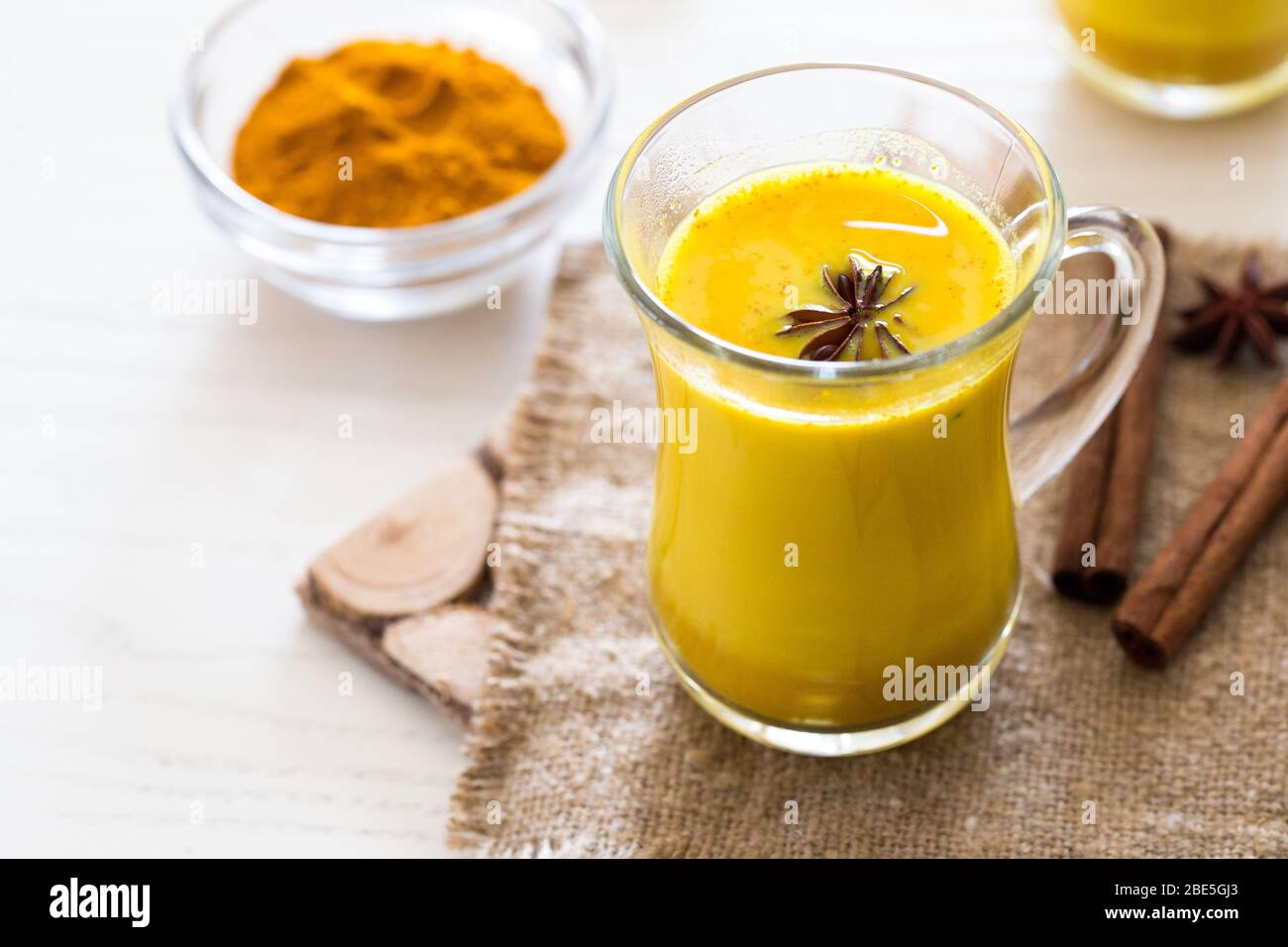 Turmeric tea drinks with milk and honey for beauty and health. Spicy