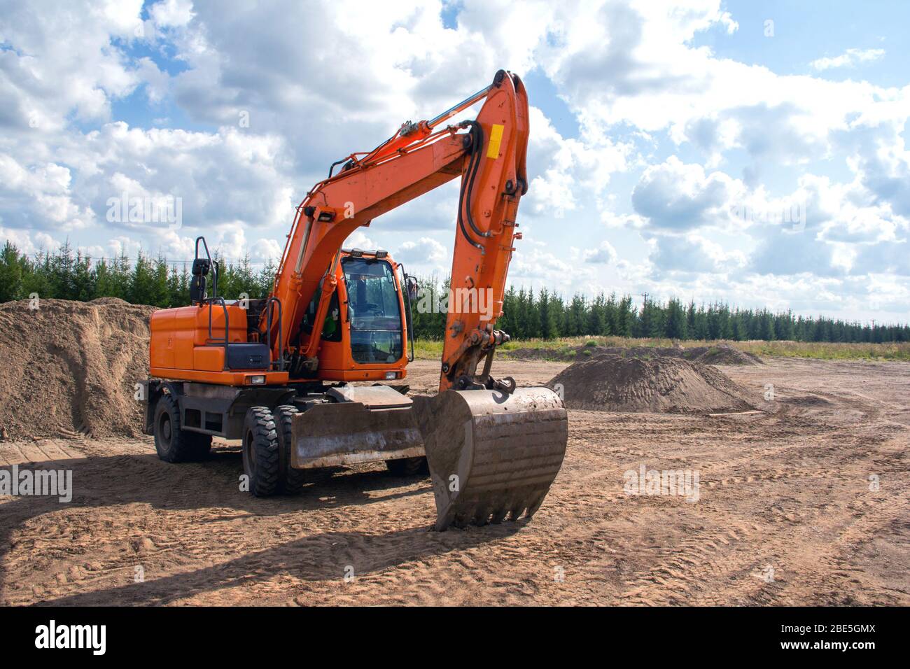 Orange construction wheeled excavator at a construction site Stock
