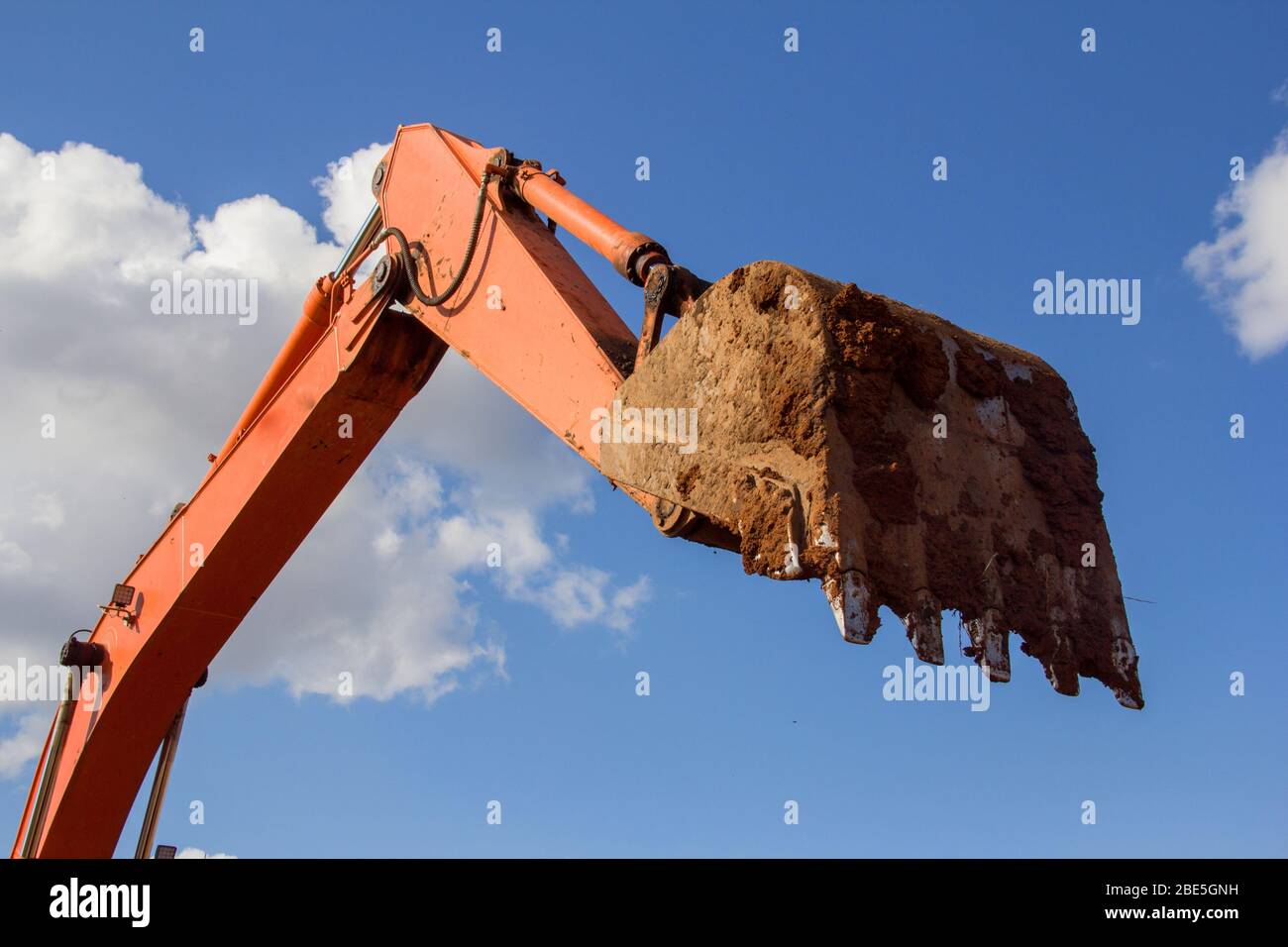 Excavator hydraulic bucket for loading materials against the sky. Stock Photo