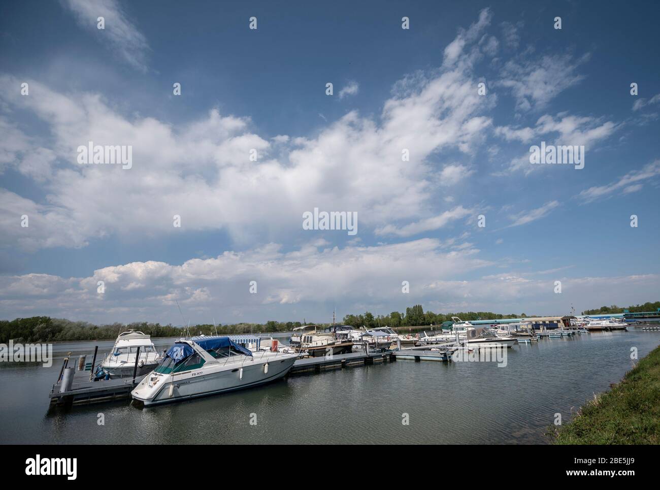 12 April 2020, Baden-Wuerttemberg, Burkheim: Motor yachts are located at the marina on the Rhine. Sports harbours were closed by the state of Baden-Württemberg with the new regulation because of the coronavirus. Photo: Patrick Seeger/dpa Stock Photo