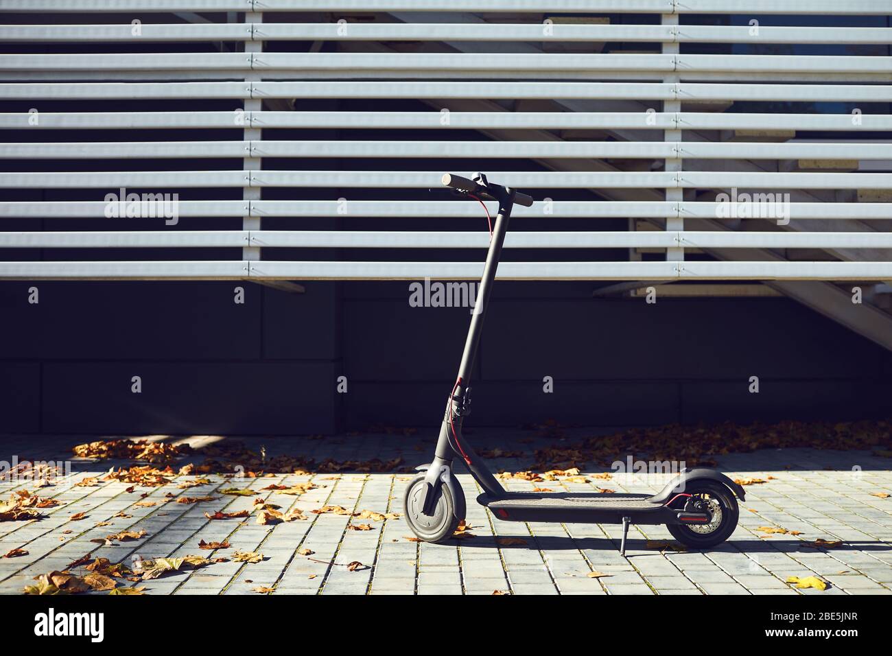 Electric scooter on a background of a wall Stock Photo - Alamy
