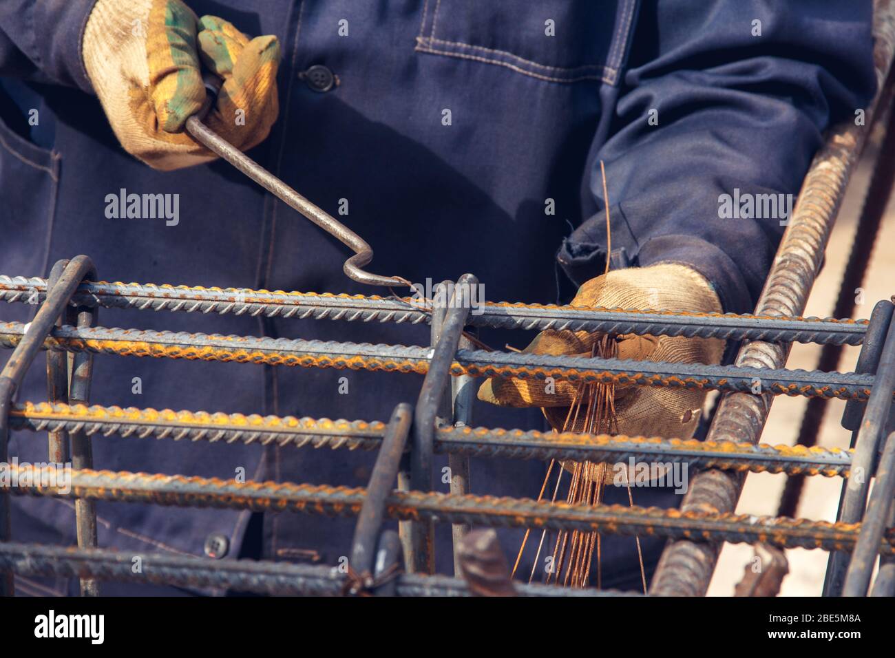 Assembly of reinforcing bars for pouring concrete. Construction worker