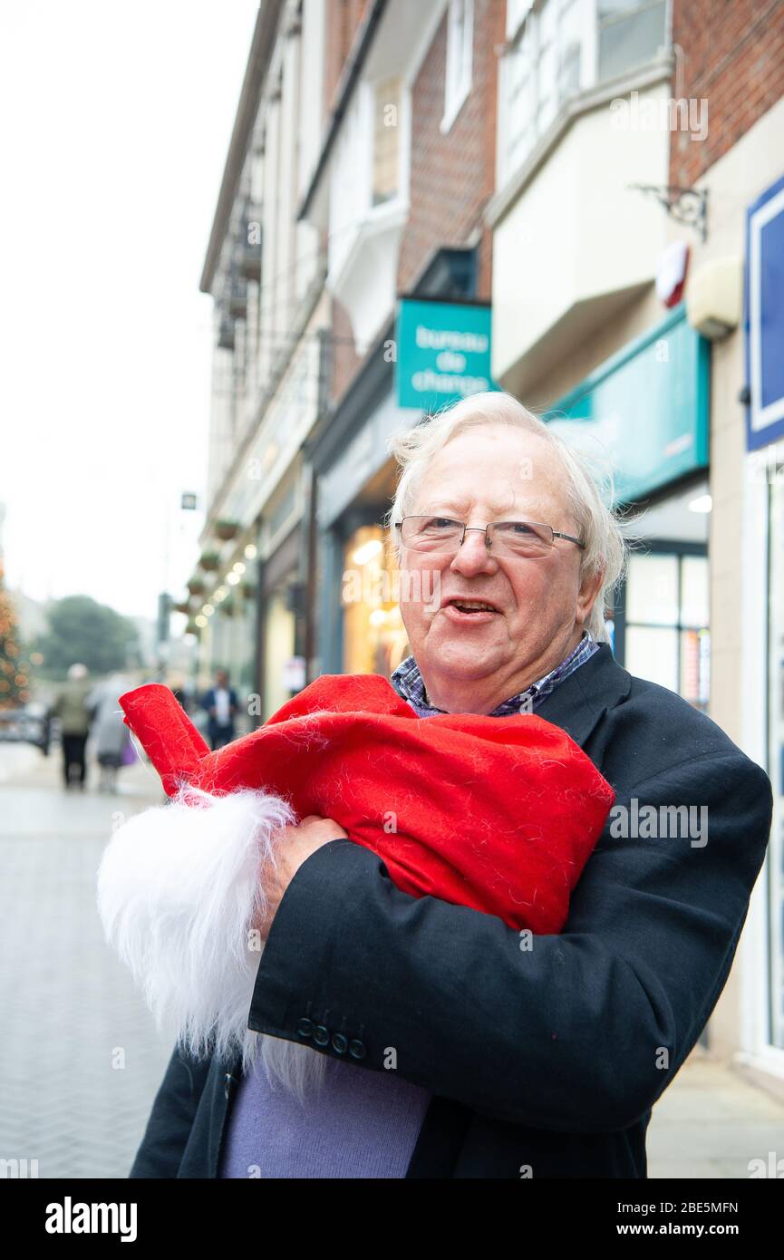 Windsor, Berkshire, UK. 21st Nov, 2019.  Comedian Tim Brooke-Taylor OBE has fun holding a santa hat following a photoshoot for the Lions of Windsor charity. Maureen McLean/Alamy Stock Photo