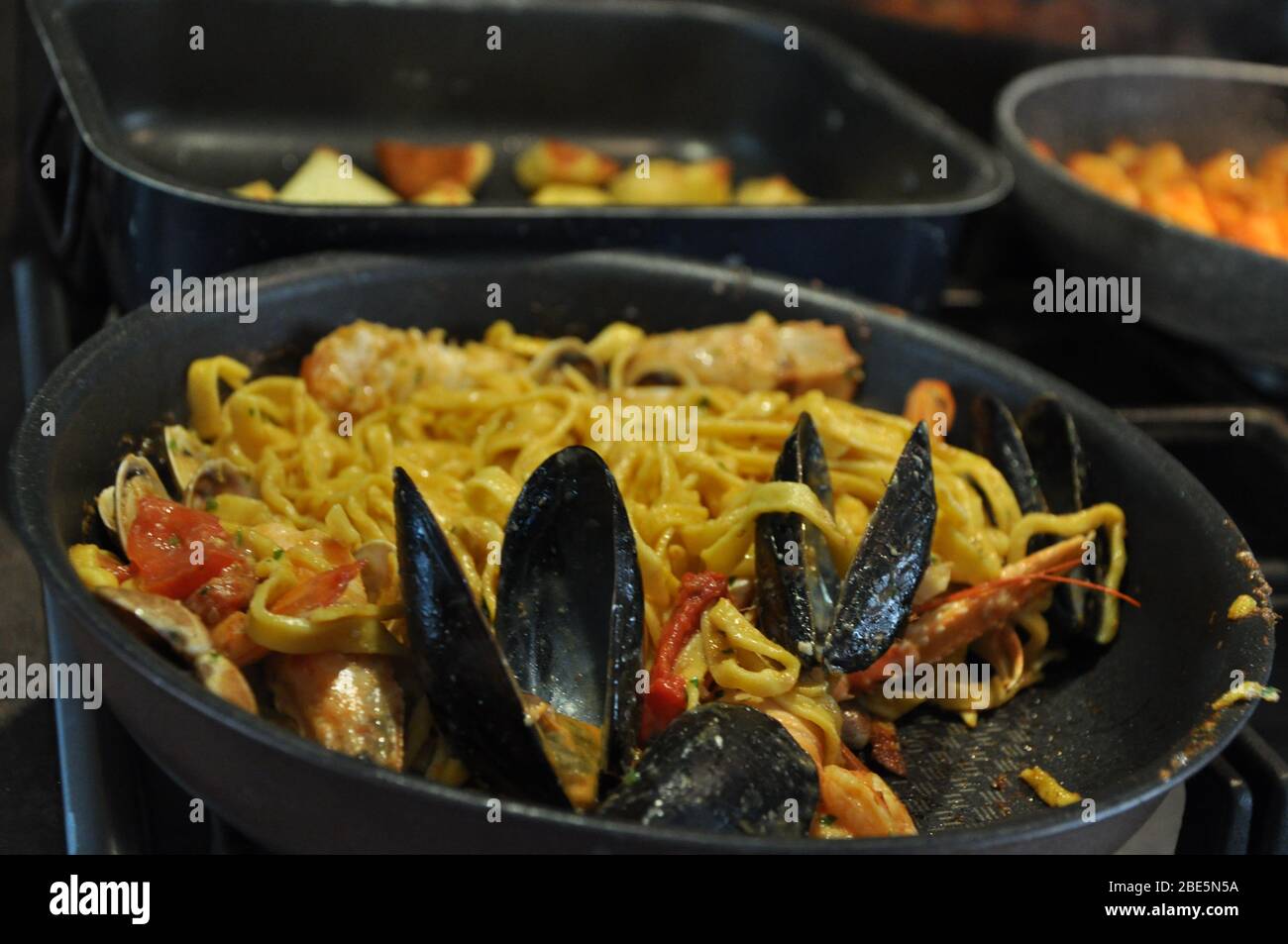 Tagliolini allo scoglio or spaghetti with seafood served i with shrimps and other shells Stock Photo