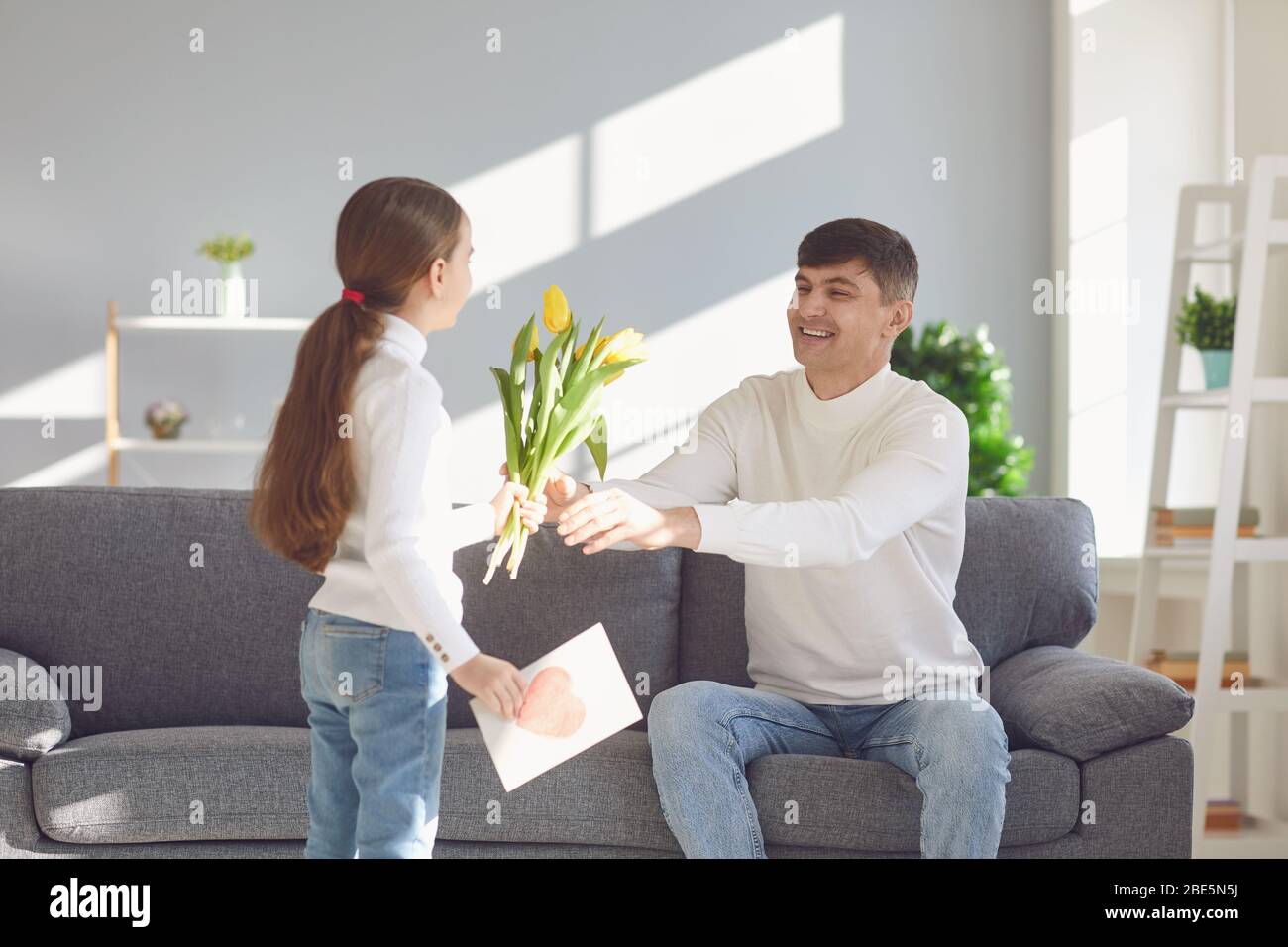 Happy Fathers Day Daughter Congratulates Dad With A Postcard In A Room With A Window Stock 1835