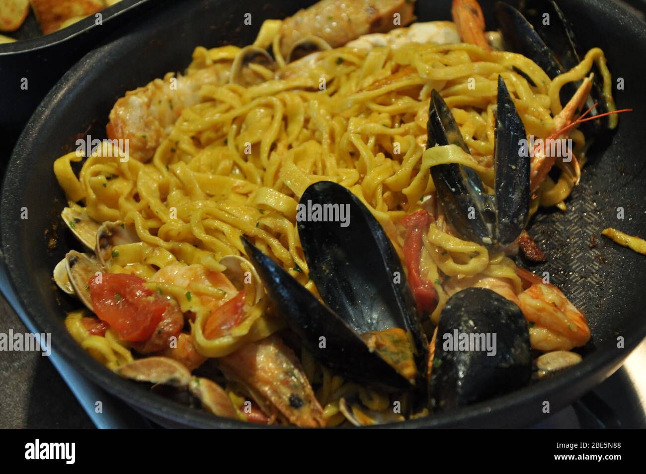 Tagliolini allo scoglio or spaghetti with seafood served i with shrimps and other shells Stock Photo