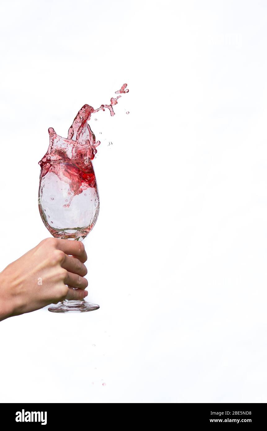 Wine splashing out of wine glass Stock Photo