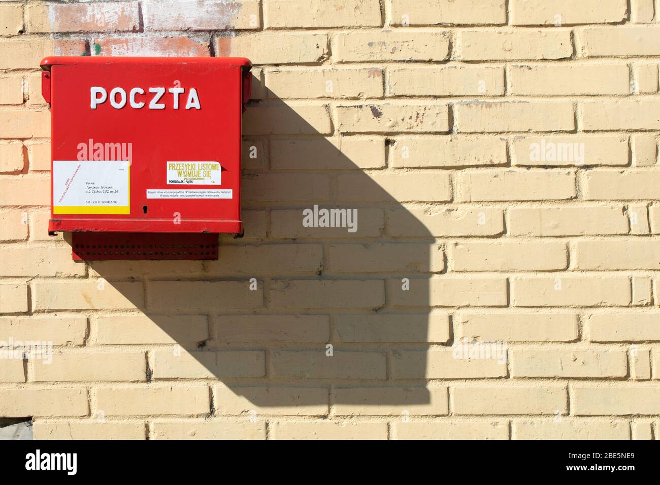 Post box and its shadow. Polish post office 'Poczta Polska', Gniezno, Poland. Stock Photo
