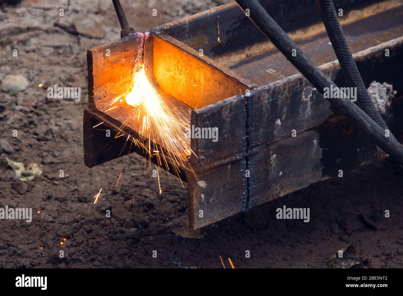 Cutting a steel beam with a gas torch. Industrial metal cutting. The