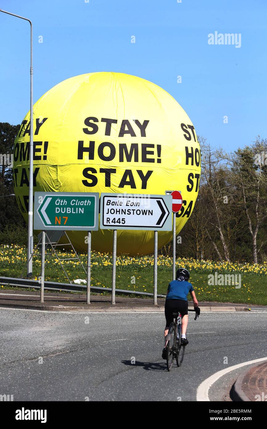 Naas, Leinster, Ireland, 11/March/2020. Covid-19 art sculpture screams Stay Home, Stay Safe, as Ireland enters its 15th day of Lockdown and faces three more weeks of staying indoors.  A Stay Home - Stay Safe message on the famous Naas Ball art sculpture, on the N7/M7 Motorway in County Kildare. Photo: Sasko Lazarov/RollingNews. Credit: RollingNews.ie/Alamy Live News Stock Photo
