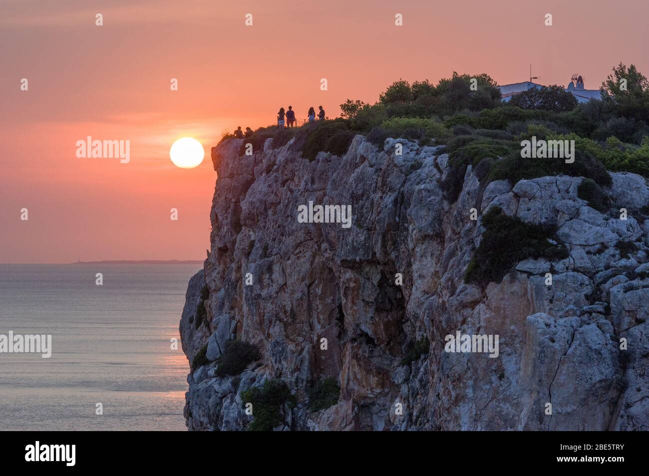 Beautiful vivid orange summer sunset over mountain top cliffs Stock Photo