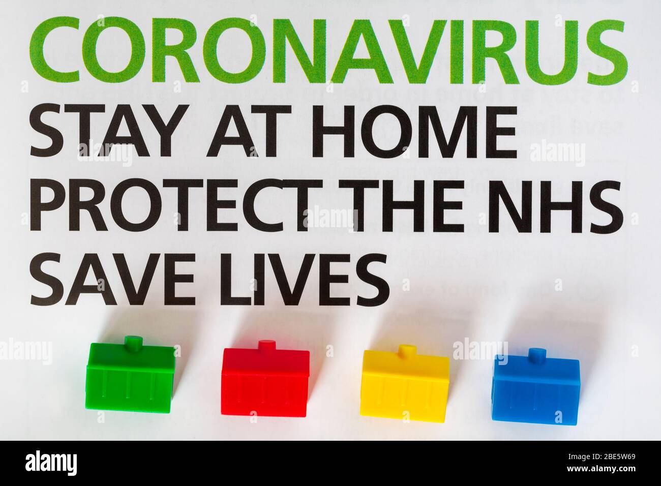 Coronavirus Stay at Home Protect the NHS Save Lives details from letter from UK Government, Boris Johnson to all UK households - with model houses Stock Photo
