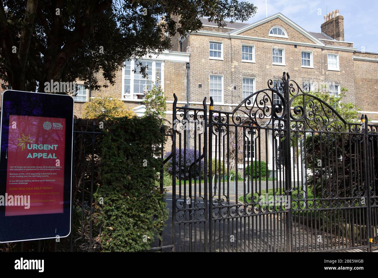 London, UK, 12 April 2020: Royal Trinity Hospice in Clapham, south London, has signs displaying corona virus information and appeals for financial support. With all their chairty shops closed and other revenue streams such as open gardens and sponsored walks not allowed, charities face severe short-falls in their fundraising because of the coronavirus. Anna Watson/Alamy Live News Stock Photo