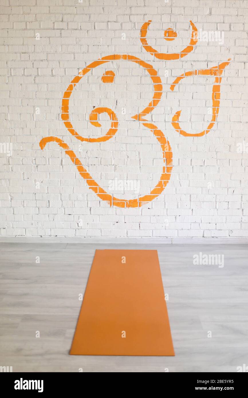 Spread out yoga Mat in orange color. Stock Photo