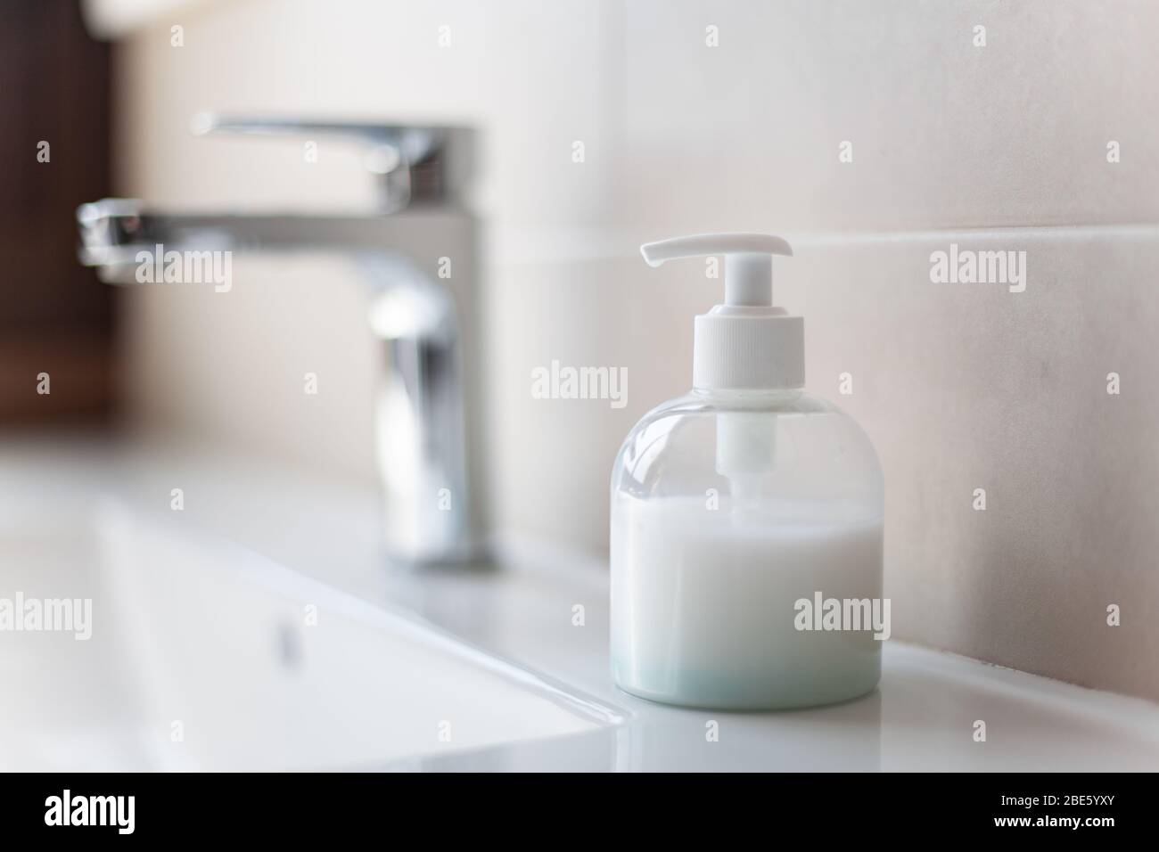 Sink soap dispenser to prevent coronavirus infection Stock Photo