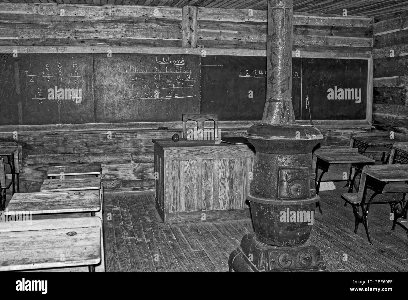 one room school, old log building, blackboard, teacher's desk, old student desks, pot belly stove, education, Hensley Settlement; black, white, Cumbe Stock Photo