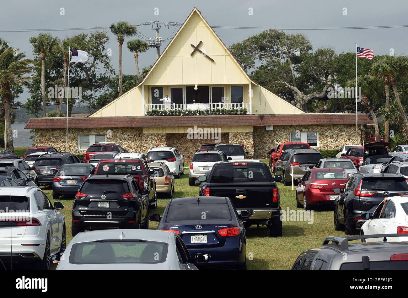 April 12, 2020 - Daytona Beach Shores, Florida, United States - People in cars attend Easter Sunday services at the Daytona Beach Drive-in Christian Church as a way to practice social distancing during the coronavirus pandemic on April 12, 2020 in Daytona Beach Shores, Florida. Florida's stay-at- home order exempts religious services, but Governor Ron DeSantis has advised against attending crowded religious gatherings. (Paul Hennessy/Alamy) Stock Photo