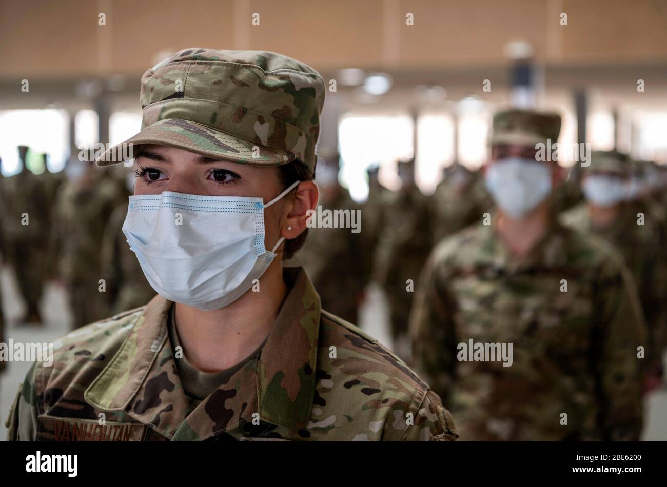 U.S. Air Force airmen wearing face masks and practicing social distancing during basic military graduation at the 321st Training Squadron Training Complex on Joint Base San Antonio-Lackland Apr. 9, 2020 in San Antonio, Texas. Due to the COVID-19, coronavirus pandemic the ceremony was closed to the public and family members. Stock Photo