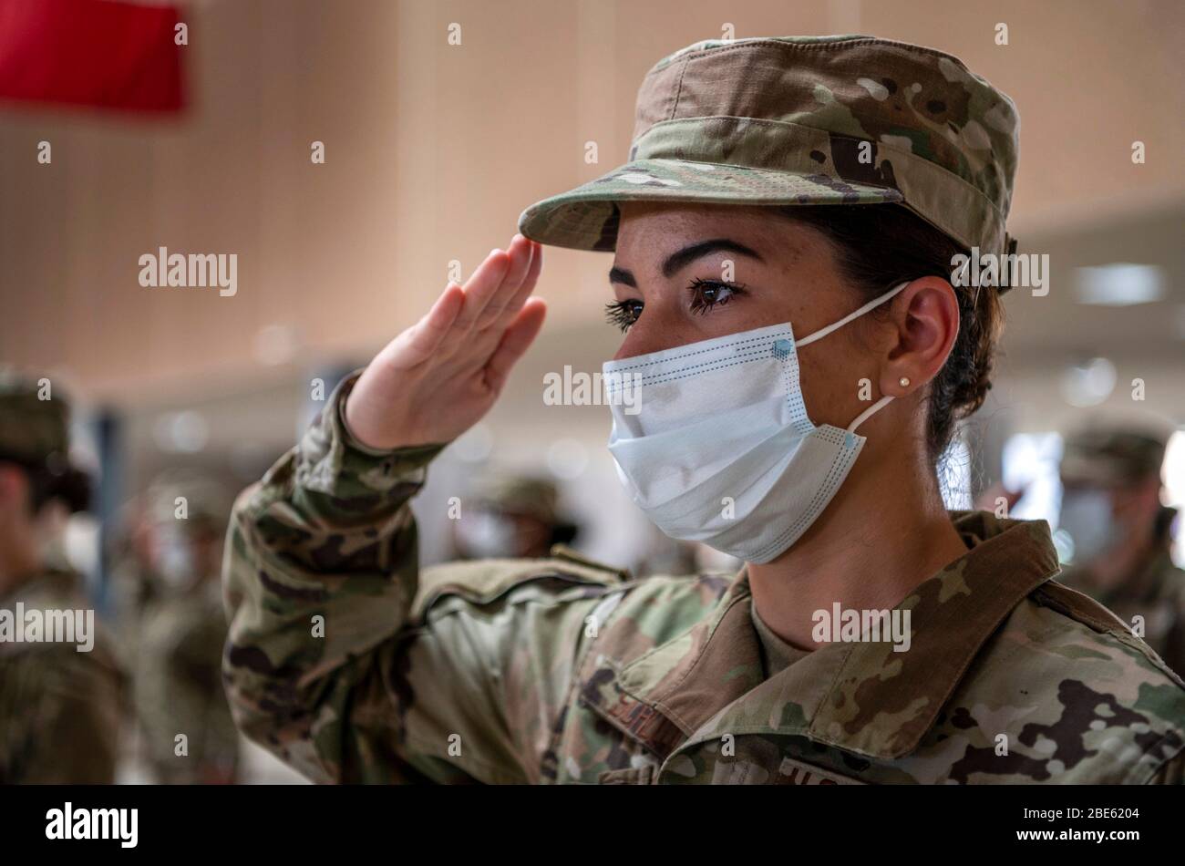U.S. Air Force airmen wearing face masks and practicing social distancing during basic military graduation at the 321st Training Squadron Training Complex on Joint Base San Antonio-Lackland Apr. 9, 2020 in San Antonio, Texas. Due to the COVID-19, coronavirus pandemic the ceremony was closed to the public and family members. Stock Photo