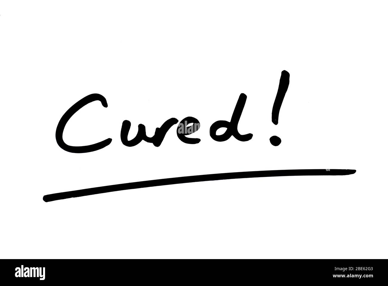 Cured! handwritten on a white background. Stock Photo