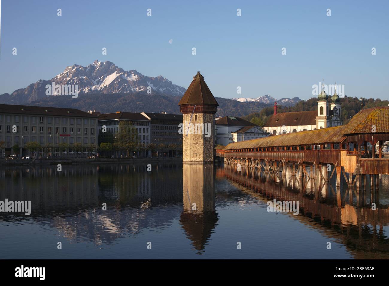 Chapel bridge with the water tower in Lucerne, Switzerland over the river Reuss is Europe's oldest wooden bridge.In the back is the Mount Pilatus. Stock Photo