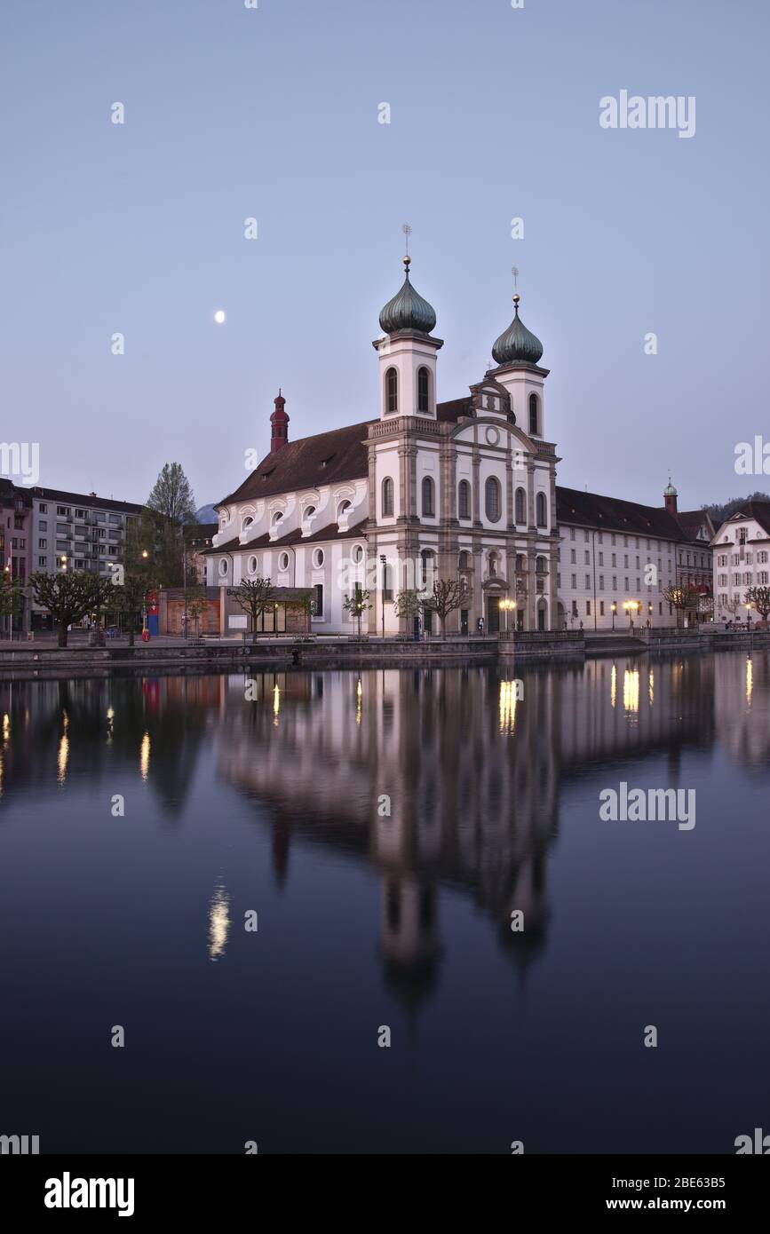 Jesuit church in Lucerne's old town in Switzerland reflecting in the River Reuss. Stock Photo