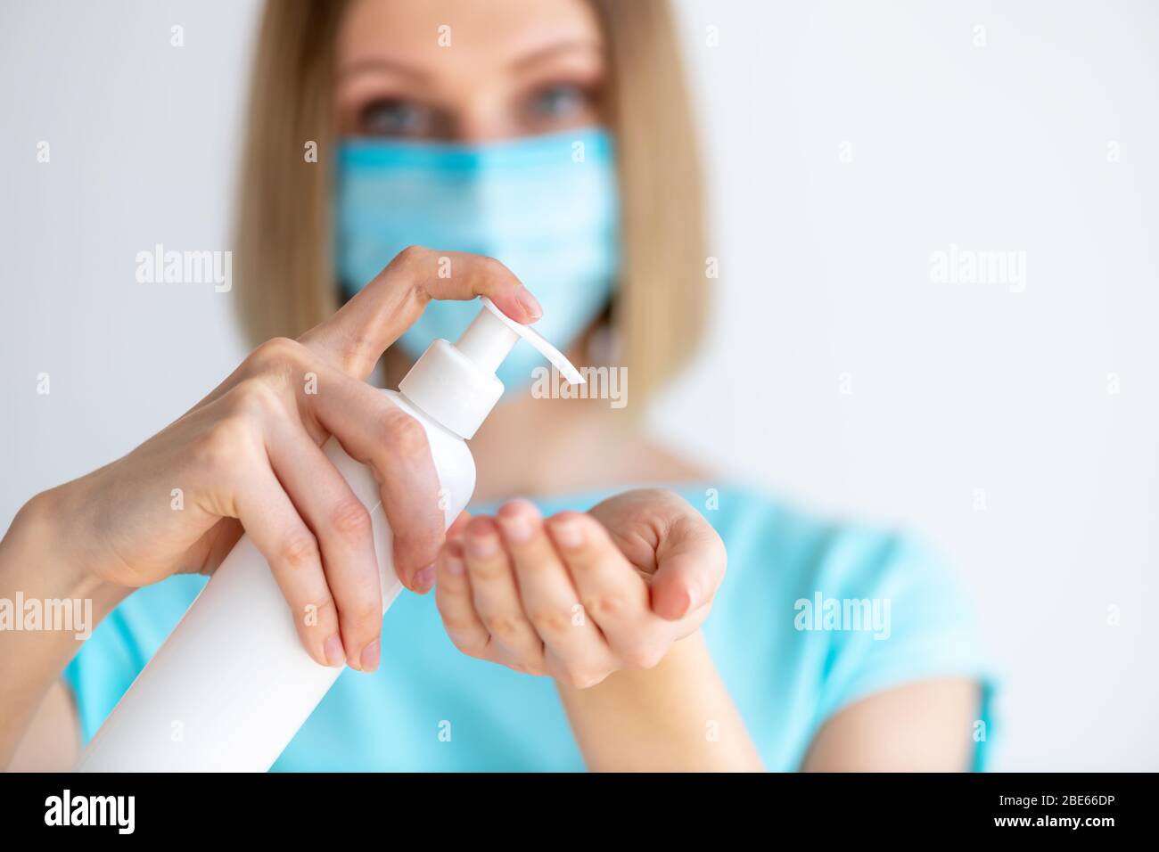 Female doctor or nurse in uniform puts a disinfectant soap on her hands. Disinfection and hand washing. Protection against virus and bacteria Stock Photo