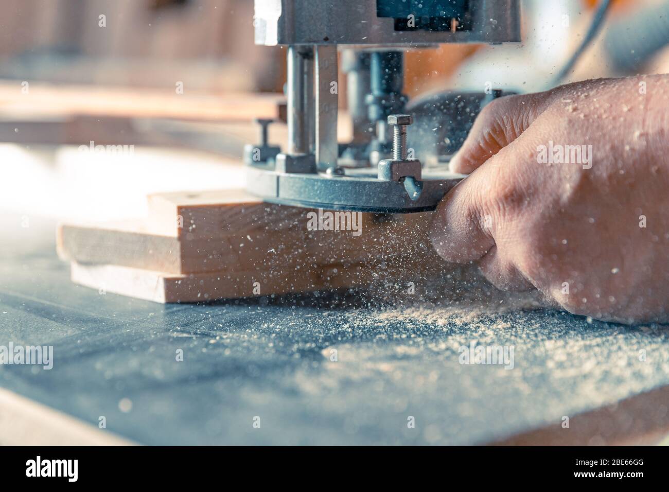 Milling wood in the joinery using manual mechanical cutters. Flying sawdust in the air Stock