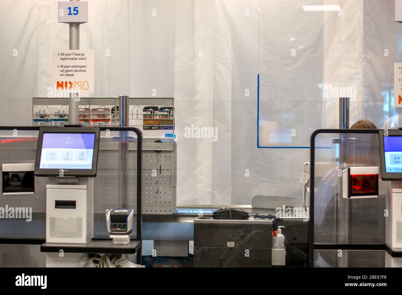 Protective plastic and plexiglass screen shields installed at the tills in supermarket to stop coronavirus spread. Cash desks with protective shields Stock Photo