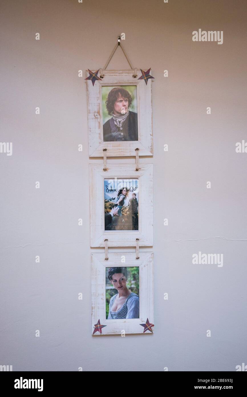 Signed photographs of the main cast members in the hit tv series, Outlander, hang on the wall inside the lobby of the Covenanter Hotel, film location, Stock Photo