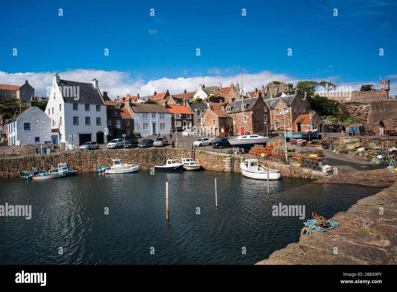Fishing village with boats tied up to the pier around the fishing harbor, Crail, Kingdom of Fife, Scotland, Europe Stock Photo