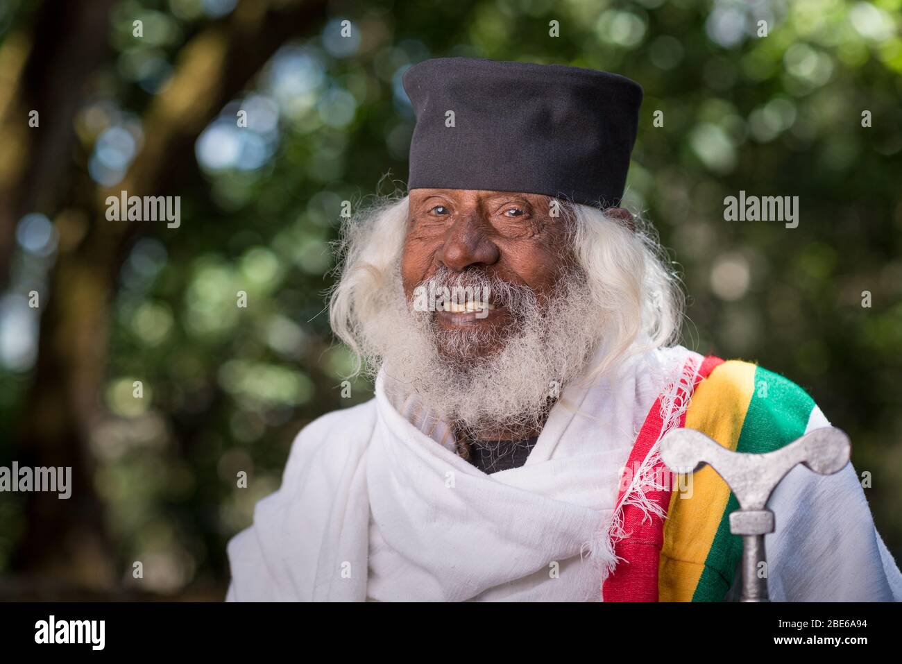 Aba Wolde Tensae in outdoor gardens holding staff, an Ethiopian Orthodox Tewahedo Church monk, Debre Libanose Monastery, Ethiopia, Africa. Stock Photo