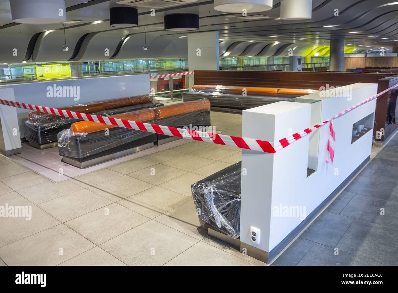 Closed places of a public catering tables and seats for people are fenced with a restrictive tape, are packed in a film. Coronavirus, Covid 19 pandemi Stock Photo