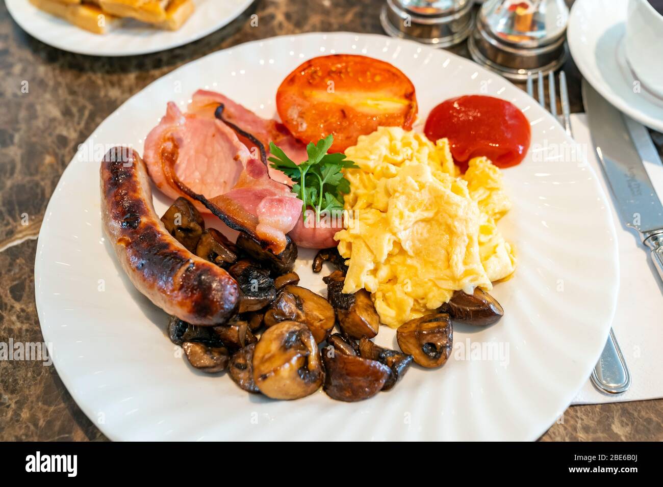Full English Breakfast on Table with coffee Stock Photo