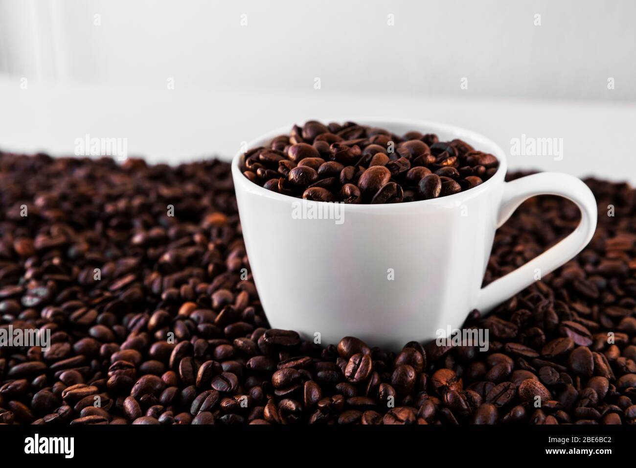 White Mug With Roasted Coffee Beans Everywhere Inside The Mug And A Lot Around It With White Background Great For Going To A Cafe Restaurant Cafet Stock Photo Alamy