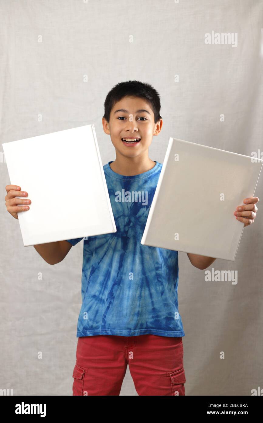 A boy holding a white board on a white background Stock Photo - Alamy