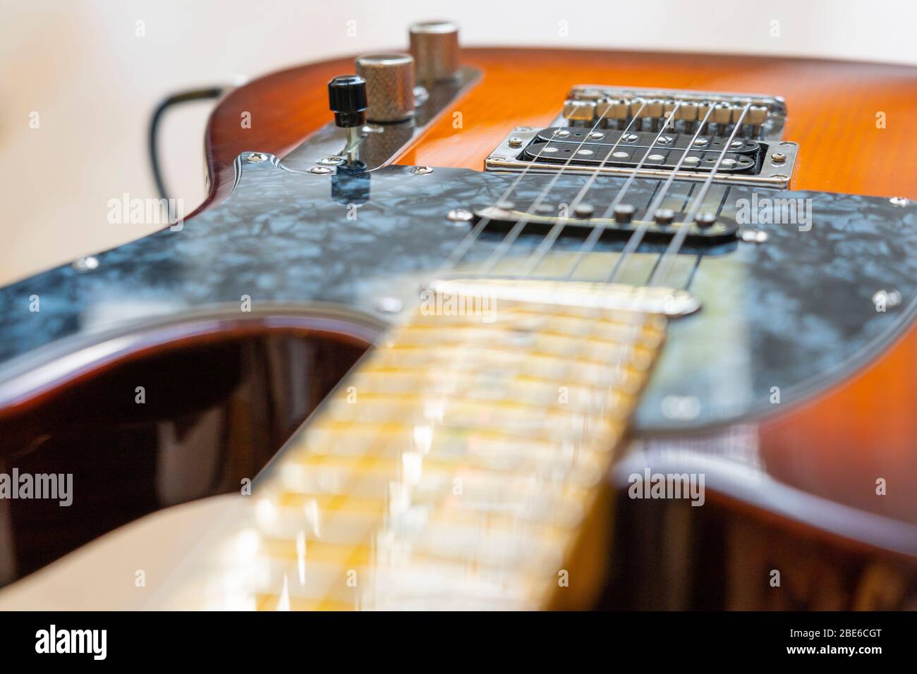 A Fender Modern Player Telecaster electric guitar with a honey burst finish, pine body, maple neck, with single coils and humbucker pickups Stock Photo