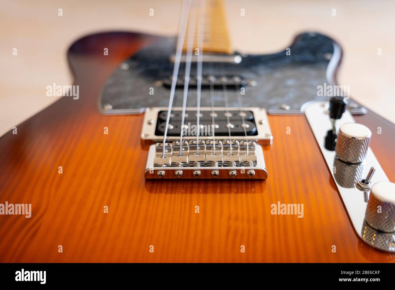 A Fender Modern Player Telecaster electric guitar with a honey burst finish, pine body, maple neck, with single coils and humbucker pickups Stock Photo