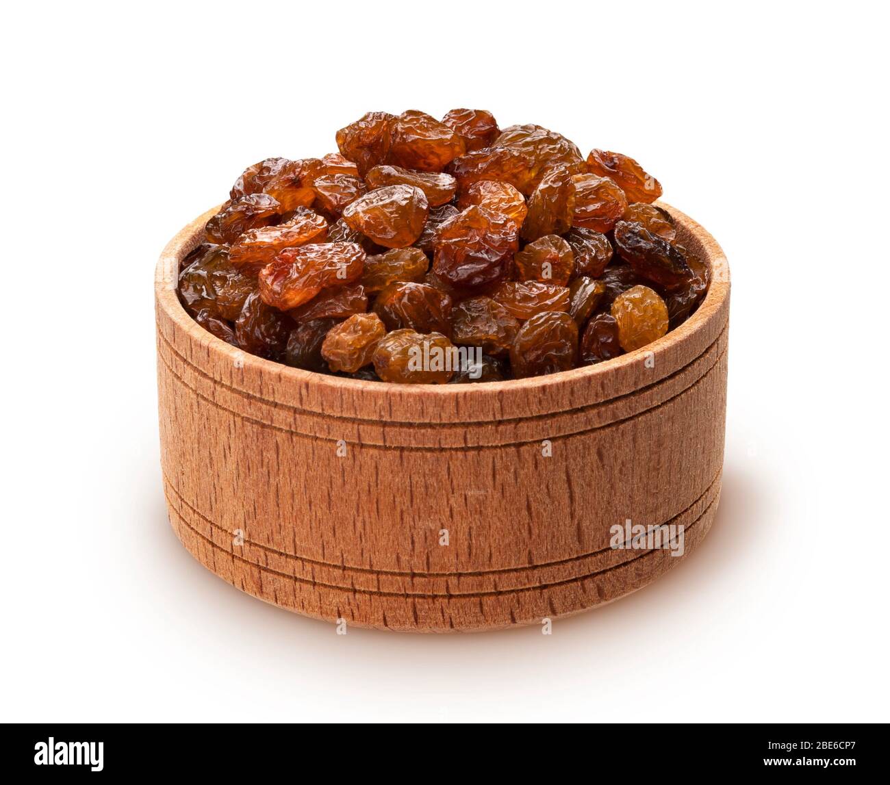 Raisins in wooden bowl isolated on white background Stock Photo