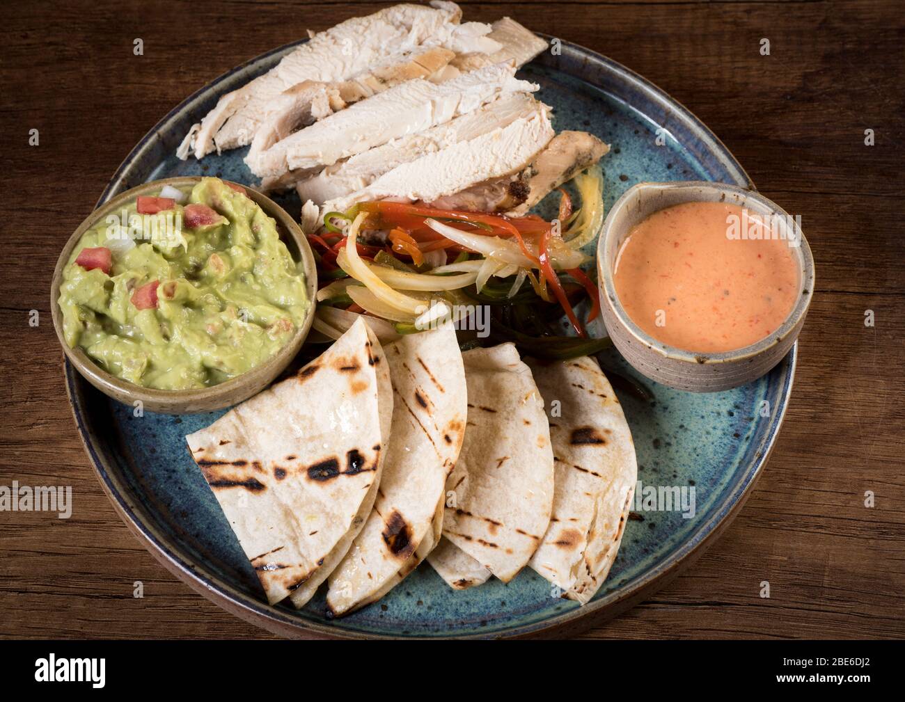 Chicken fajitas with grilled onions and bell peppers and serve with