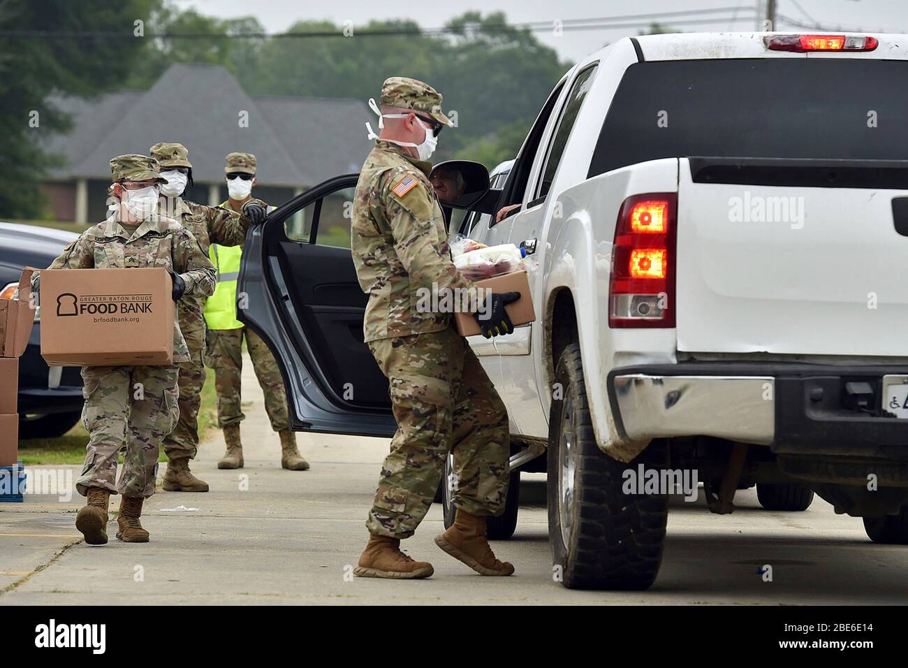 Louisiana National Guardsmen load boxes of food aid people suffering from the effects of the