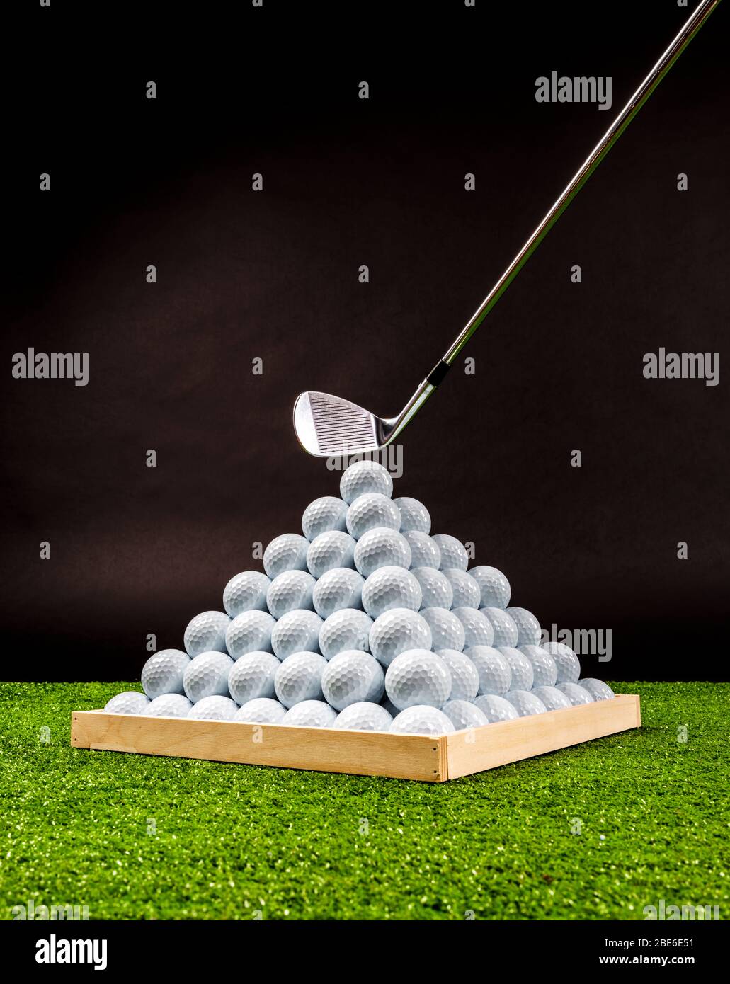 Pyramid of golf balls in a driving range, vertical image Stock Photo
