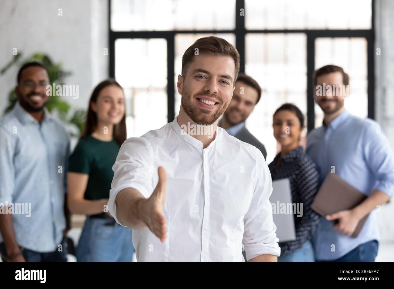 Happy businessman stretch hand greeting newcomer in office Stock Photo ...