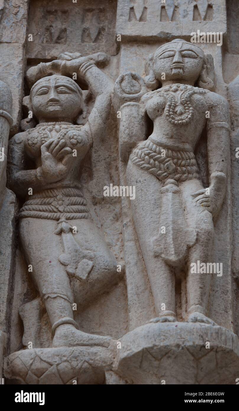 Posing female sculptures carved into the exterior walls of the ornate Jagdish Temple of Vishnu, Udaipur, Rajasthan, India, Asia. Stock Photo