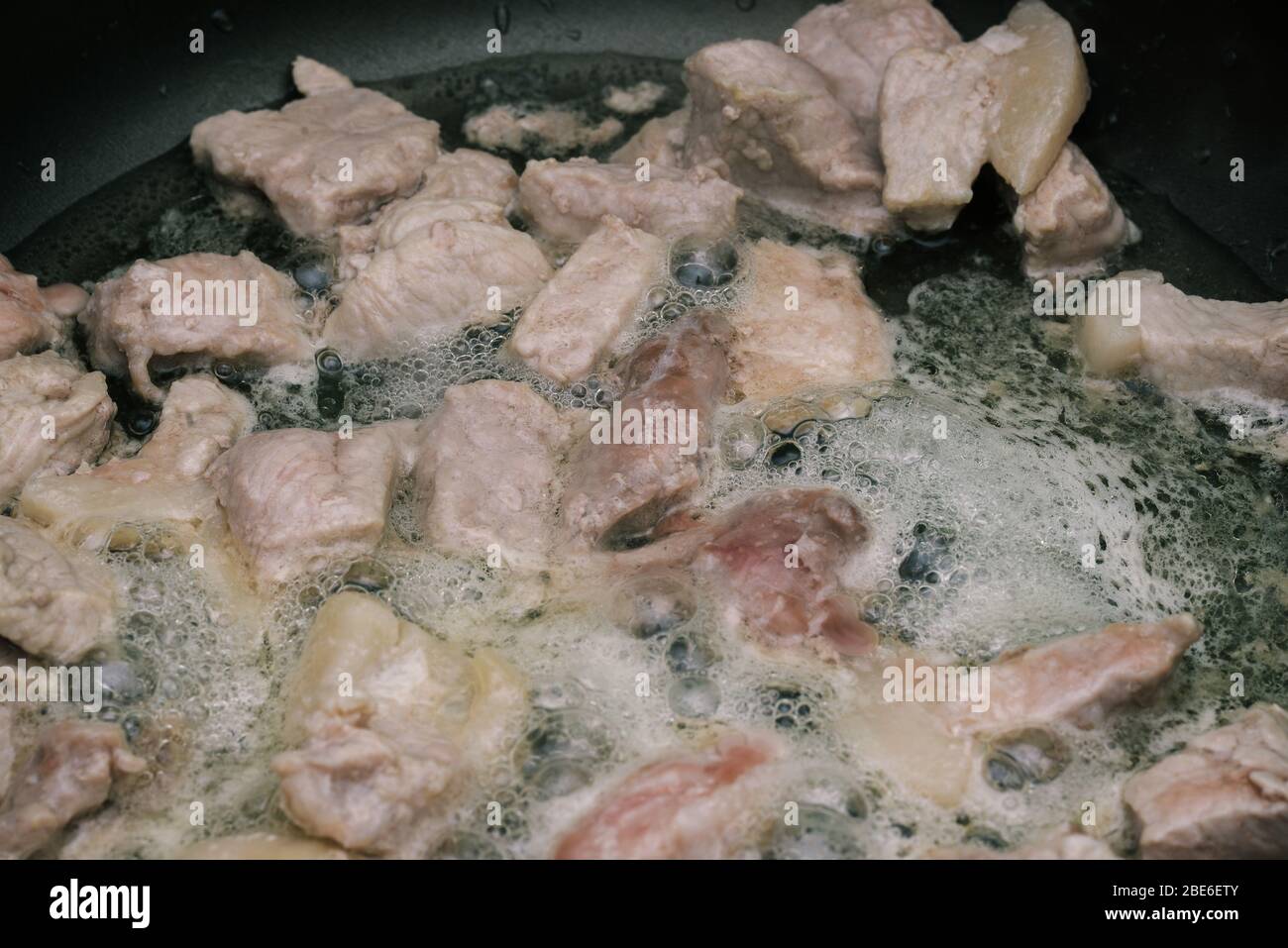 https://c8.alamy.com/comp/2BE6ETY/pieces-of-raw-meat-with-vegetable-oil-are-fried-in-a-pan-the-process-of-cooking-the-meat-is-cooked-in-a-pan-close-up-2BE6ETY.jpg