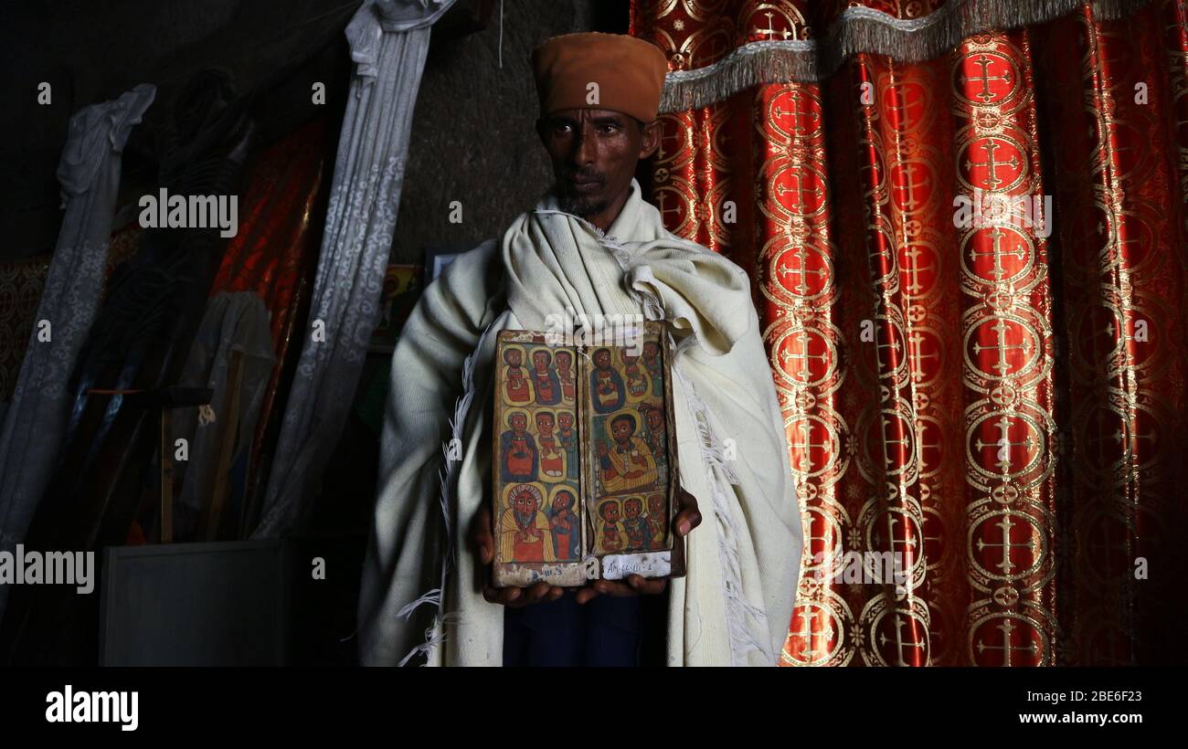 Ethiopian Christian monk in Asheton Maryam Monastery in Amhara Region, Ethiopia,  shows ancient Christian icons held at the monastery Stock Photo