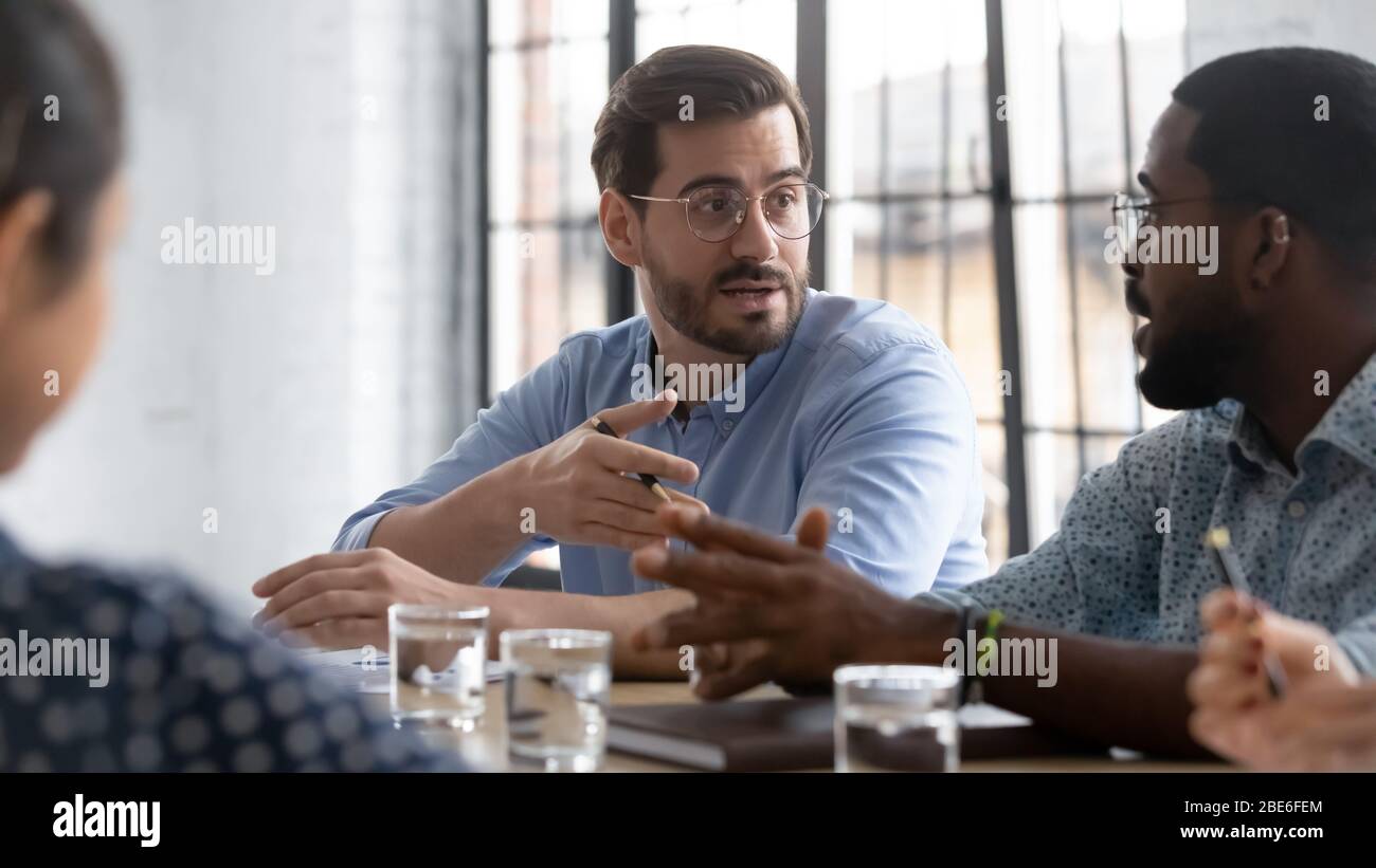 Multiethnic businesspeople gather at briefing brainstorming together Stock Photo