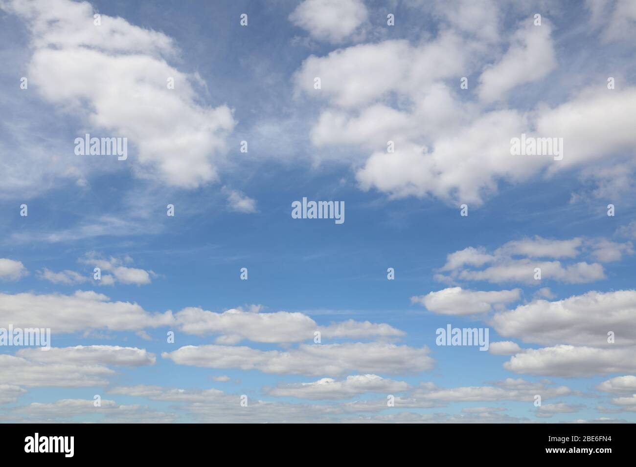 Fluffy white clouds in a blue sky Stock Photo - Alamy